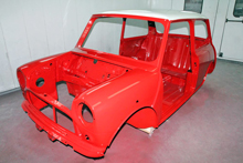 Classic Mini body shell painted red with white roo