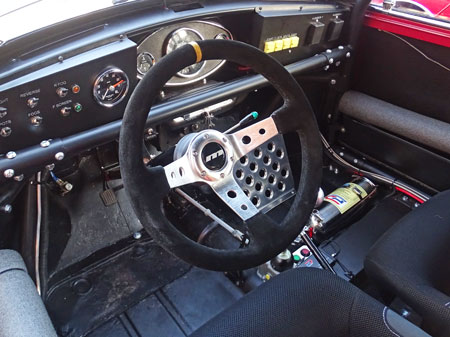 Dashboard of a classic Mini, fitted with Moutney steering wheel.
