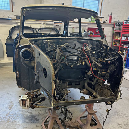 A classic Mini S5 LE that has ben stripped due to rust.