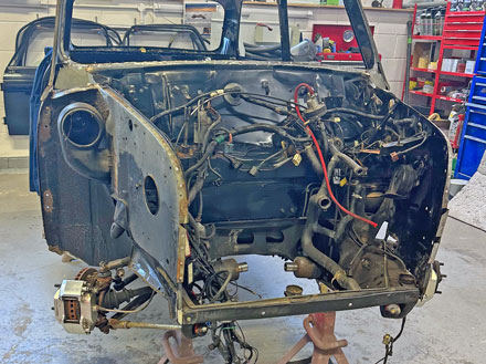 Engine bay stripped out of a classic Mini as part of the restoration process.