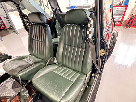 Original front seats reinstalled into a Mini restoration project.