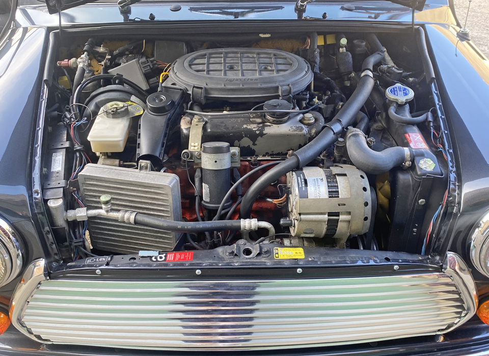 Under bonnet view of the engine bay in 1997 Rover Mini, showcasing its 1.3MPi engine and excellent condition.