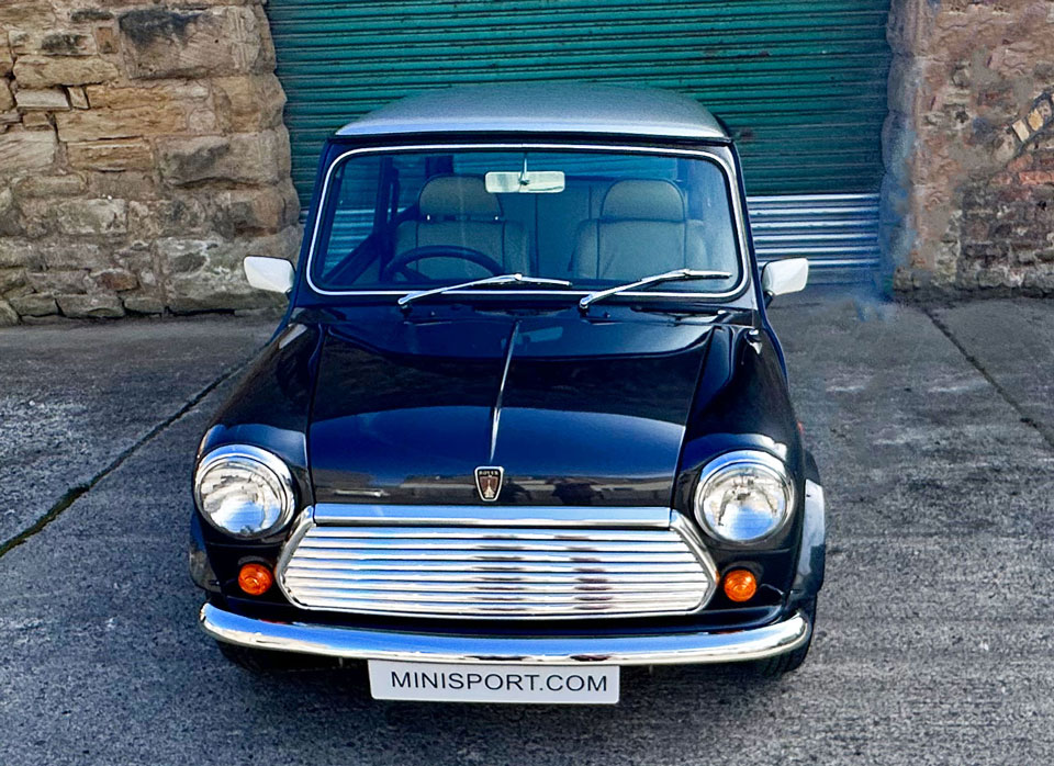 Front view of 1997 Rover Mini, featuring its classic design and rare Anthracite Black color with striking silver roof.