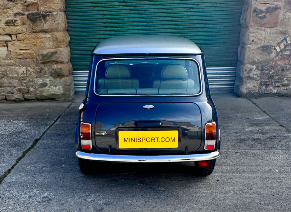 Rear view of 1997 Rover Mini, highlighting its Anthracite Black body with silver roof and timeless design.
