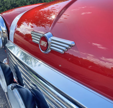 Mini Coopr Badge, fitted onto a Restored Mini Cooper Mpi, finished in Flame Red with a white roof.