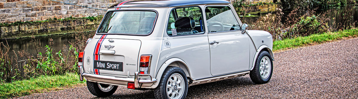 Rear of 'Merlin' a converted Classic Mini painted in Old English White with a Black roof.