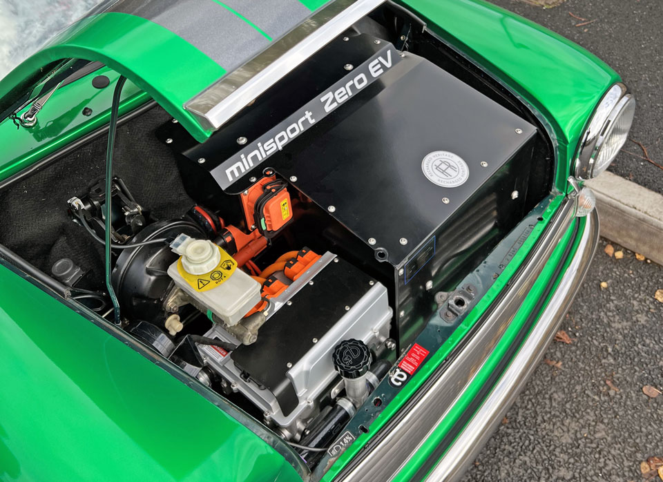 Under bonnet view of 1995 Mini Cooper EV, showcasing its electric system and modern technology.