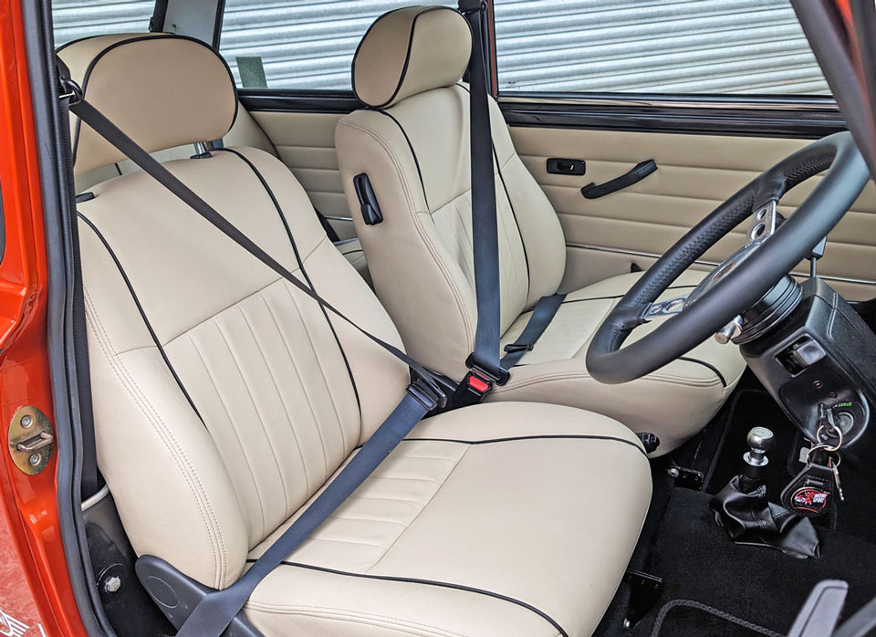 Interior view of the cream leather seats with black piping
