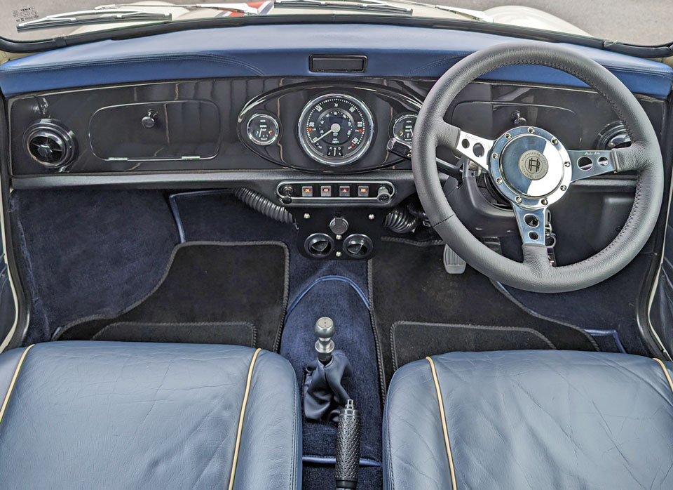 Piano black dash in 1999 Mini Cooper 40 EV 'Merlin', featuring a sleek and modern interior design.