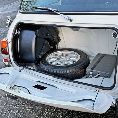 Inside a Mini Cooper Spi boot, showing the fuel tank and spare wheel.