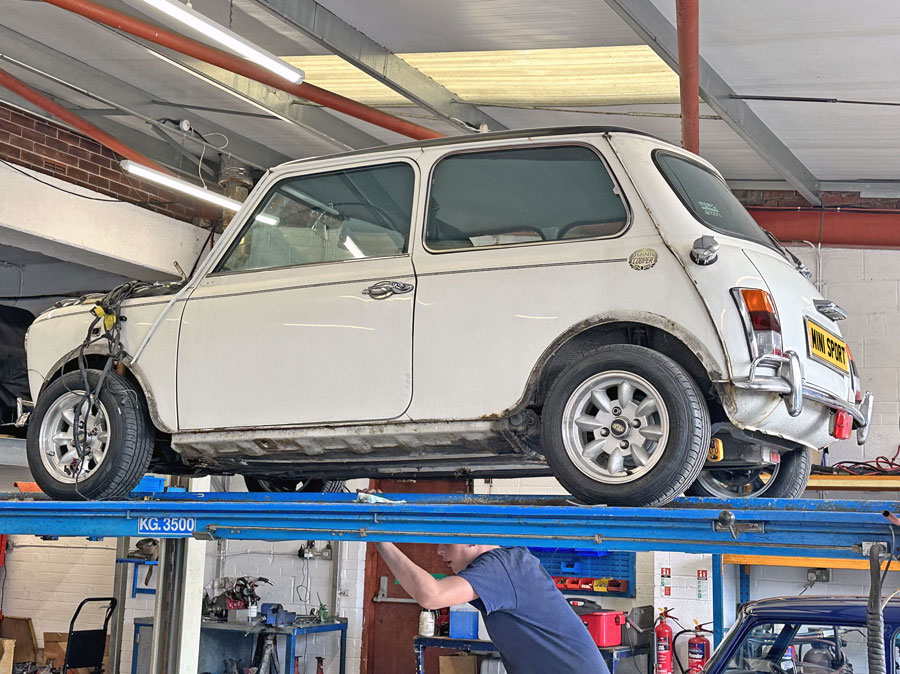 Mini Cooper Spi, being stripped on the garage ramps in preparation for a rebuild.