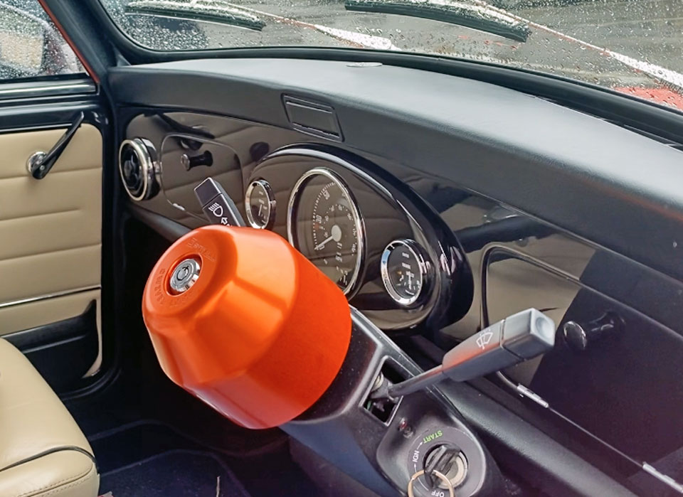 Dashboard of the Mini Cooper EV, featuring the piano black dashboard and swivel lock cover