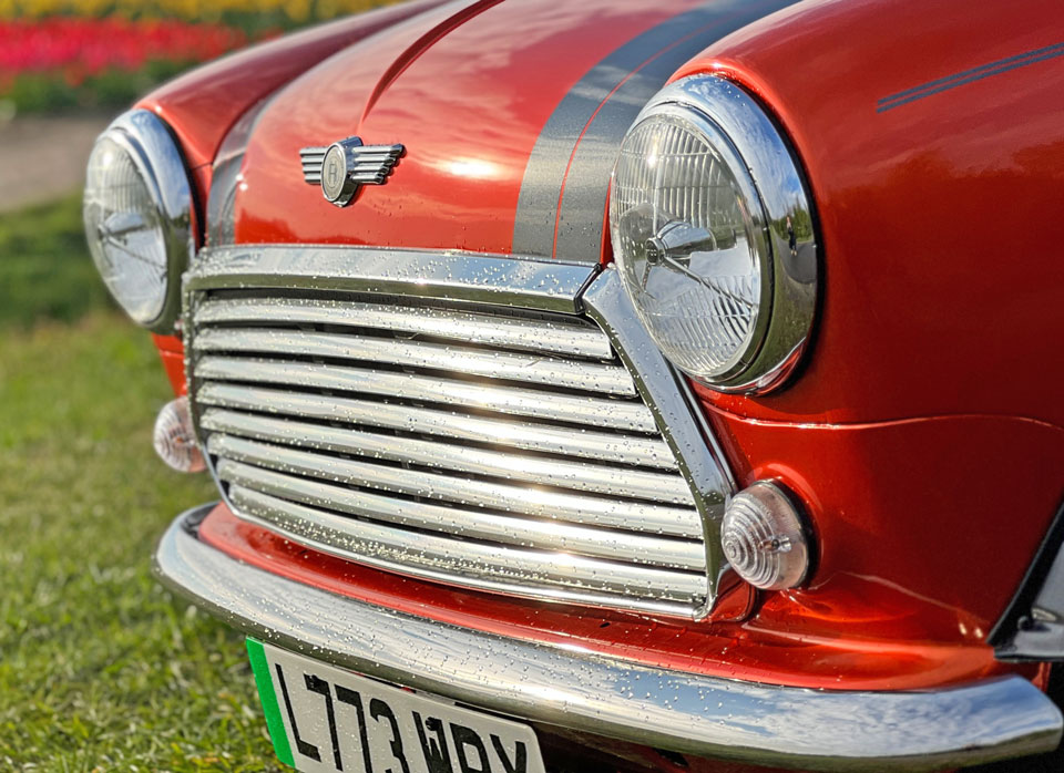Close-up of the grille and lights on the Mini Cooper EV, featuring modern design elements and innovative lighting technology.