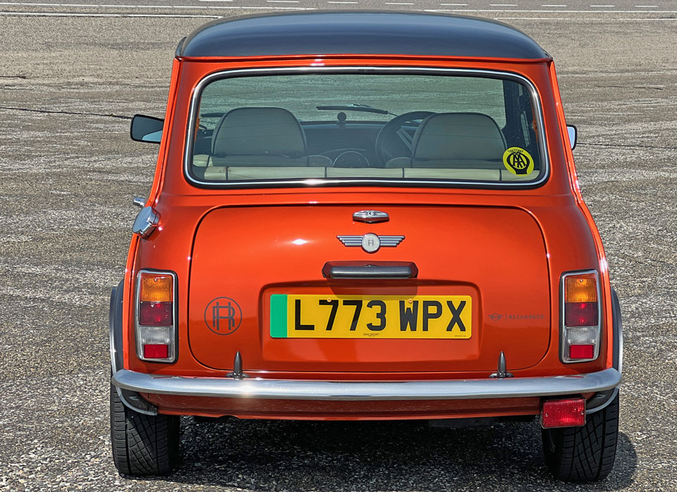 Rear view of the Mini Cooper EV, highlighting its classic design