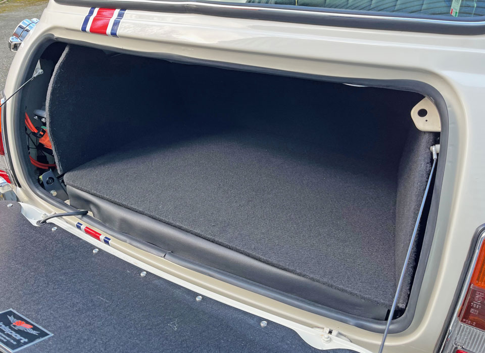 Carpeted boot protection kit, fitted into a Mini EV for sale.