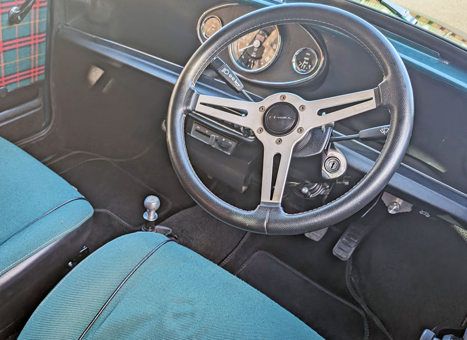 Classic mini EV for sale with a black dashboard, and Momo steering wheel on a quick release boss.