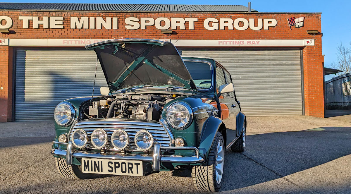 Mini Cooper outside of Mini Sport with engine on display