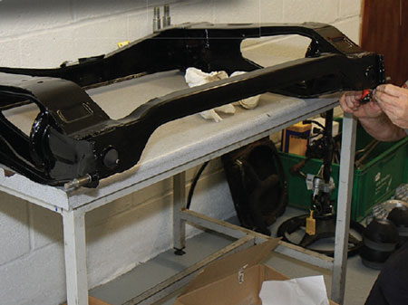 Assembling rear subframe and suspension system on bench