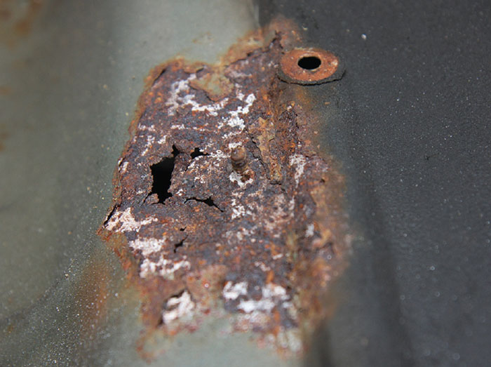 Corrosion around the heat shield mounting points on a classic Mini.