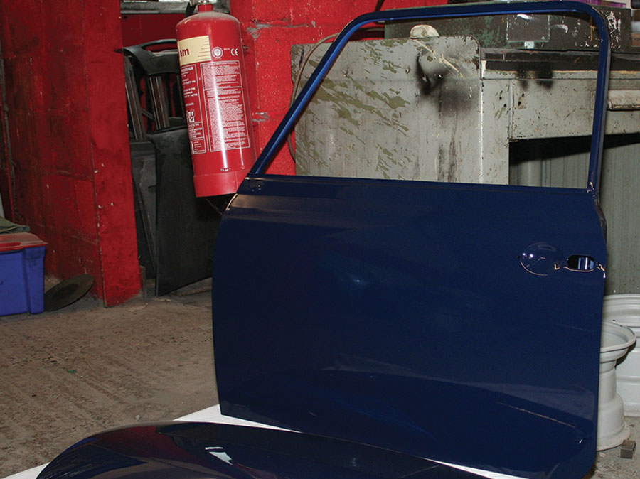 A freshly painted Mini door and boot lid with a smooth, glossy finish, completed by Mini Sport Ltd.