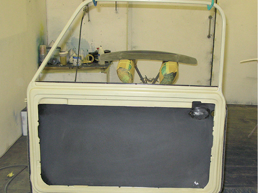 Inner panel of a Mini door with the window winder mechanism removed to save weight.