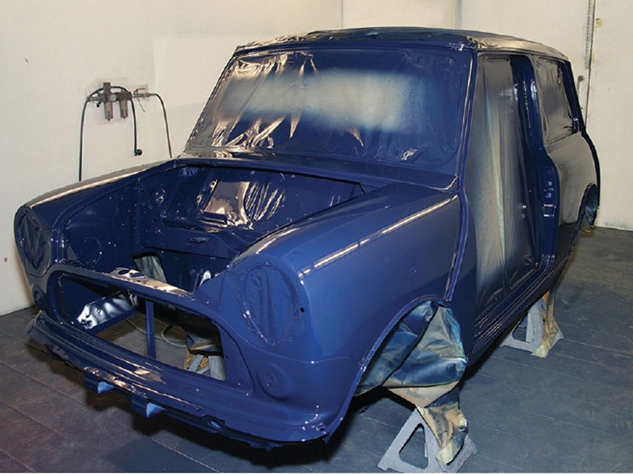 Final coat of Rover Eclipse Blue paint applied to a Mini shell.
