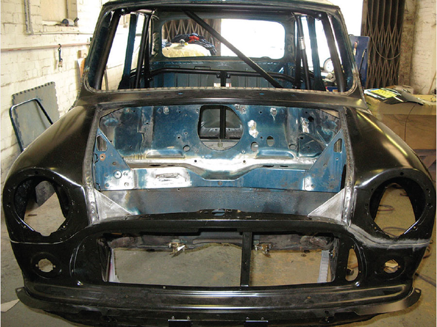 Front section of a Mini shell with the bulkhead visible, during the repair process.