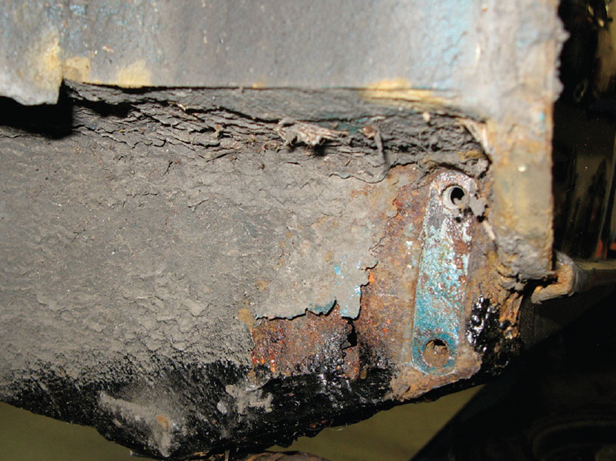 Stripped down corroded area on a classic Mini where the subframe bolts to the heelboard.
