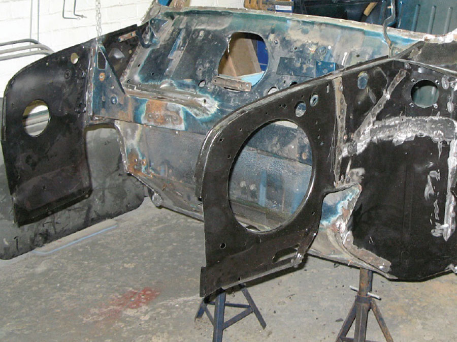 Mini shell with a new inner wing panel welded on, showcasing the different repair techniques
