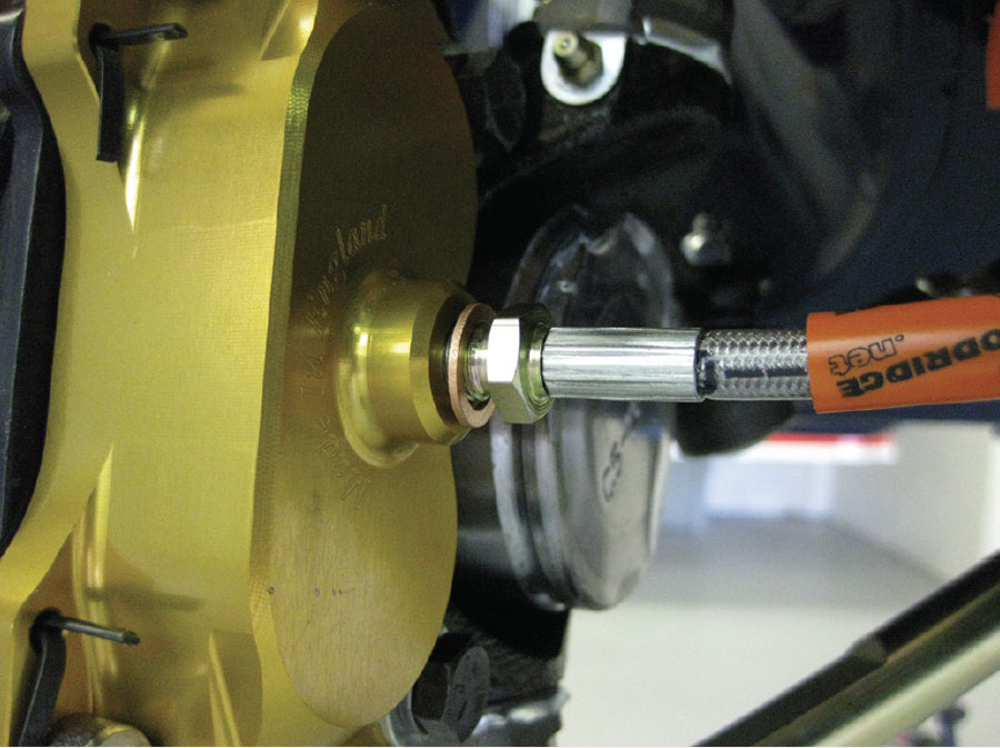 Steel hoses connecting brake calipers to the front subframe