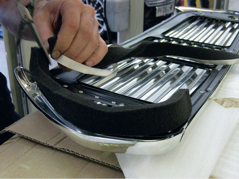 Applying foam strips to the ends of the Mini grille to protect paintwork from scratches.