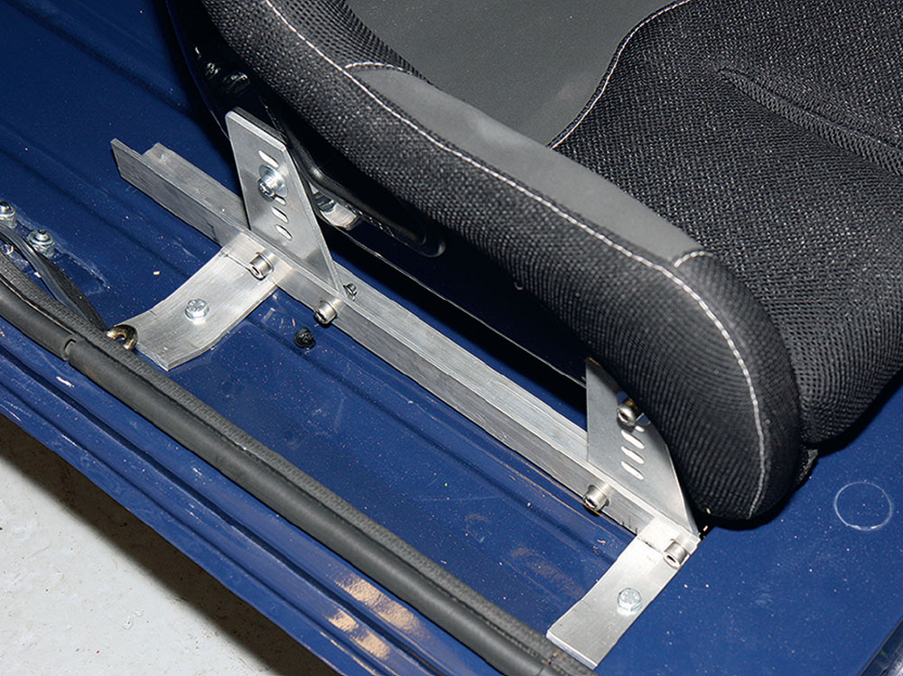 Custom seat bracket securely fitted with Cobra seat for motorsport