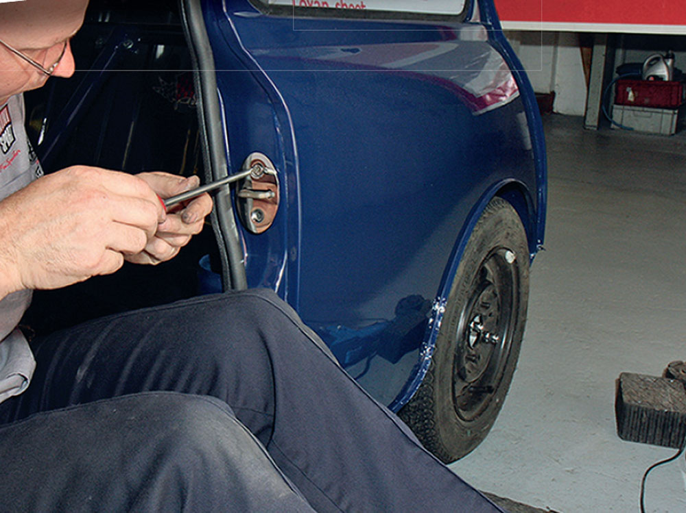 Fitting stainless striker plates to the doors of the Bogus 2 Mini for improved durability and style.