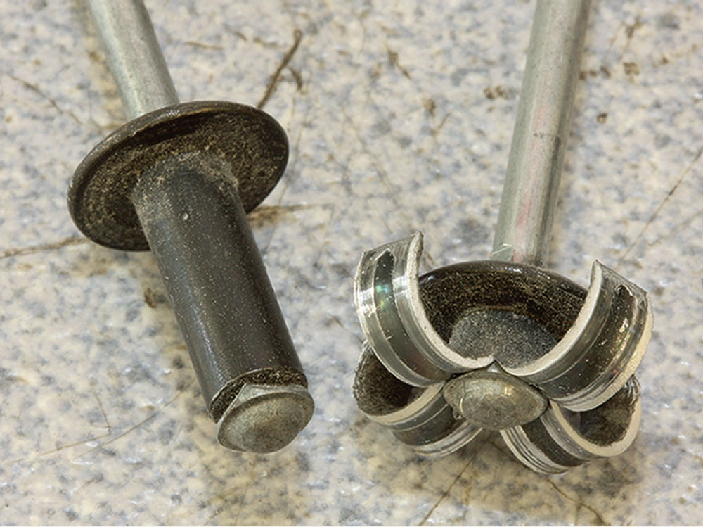 Comparison of two pop rivets: one fired and split open, the other unfired with a square edge.