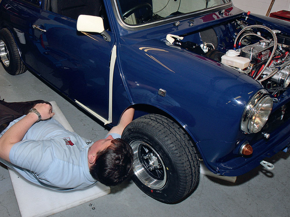 Aligning the doors on the Bogus 2 Mini with tape protection and hinge shimming for perfect fitment.