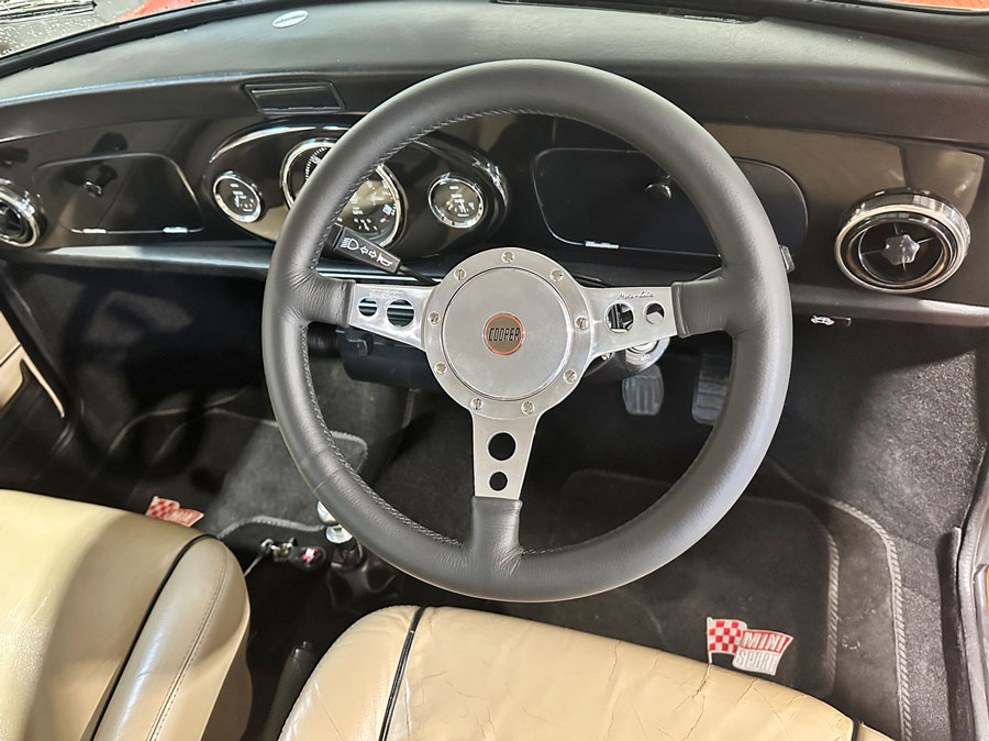 Leather cooper steering wheel, fitted into a classic Mini.