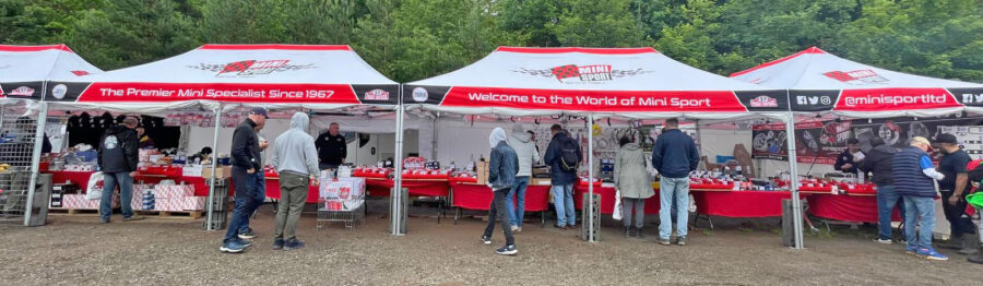 Mini Sport UE stand at IMM, assisting customers and showcasing classic Minis.