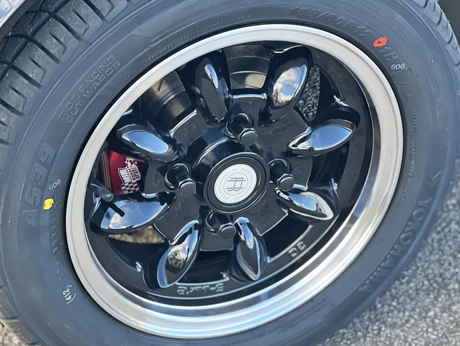 'Spectre' the bespoke Classic Mini EV close up of black alloy wheel, and Mini Sport brake caliper in red