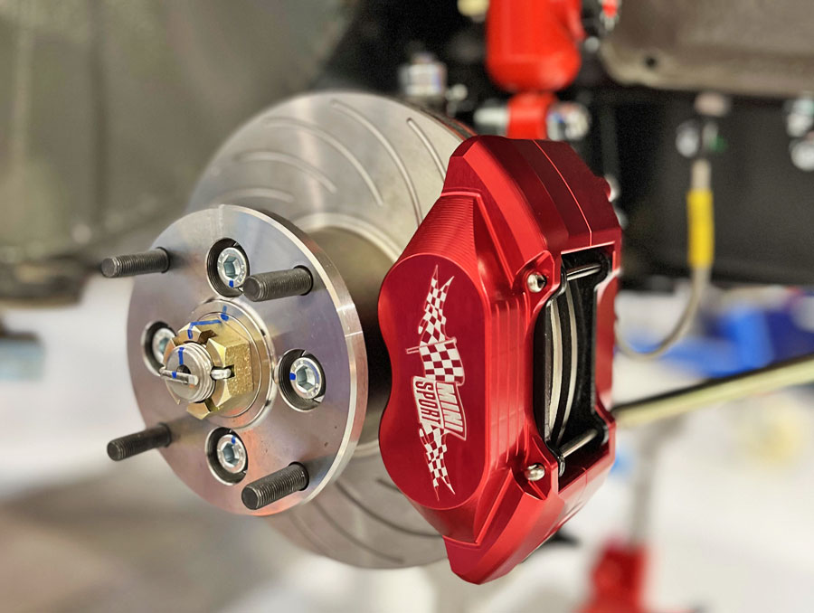 Mini Sport alloy 4 pot brake calipers in red fitted with performance disks on 'Spectre' Mini EV