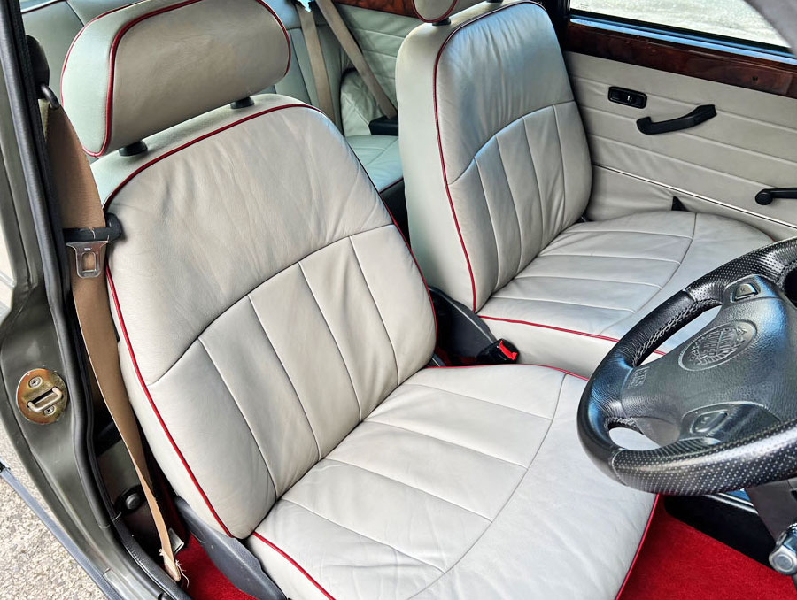Classic Mini Cooper showing the original cream leather with red piping seats