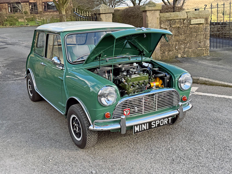 a Mk1 classic Mini Cooper in Almond Green with the 1.3 Cooper Engine showing
